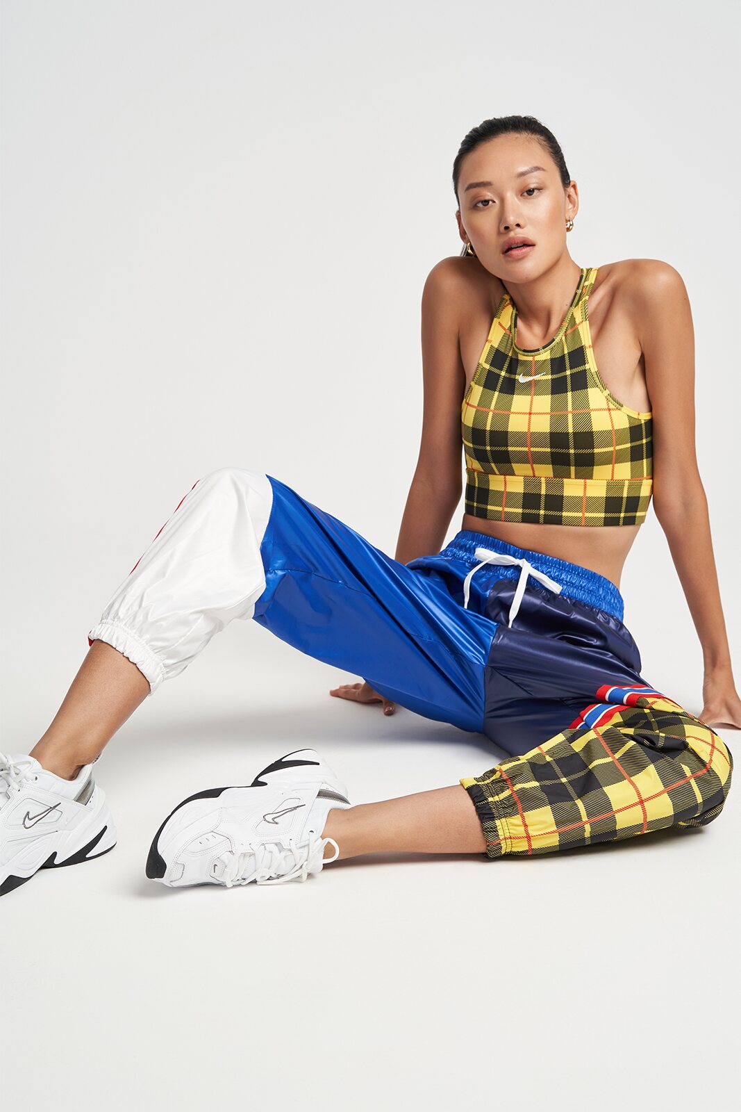 Fashion model seated in blue and yellow sportswear